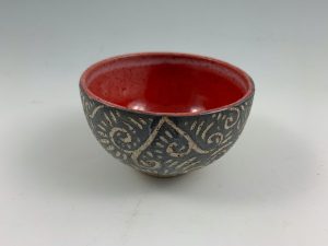 small red sgraffito bowl