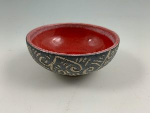 small red sgraffito bowl